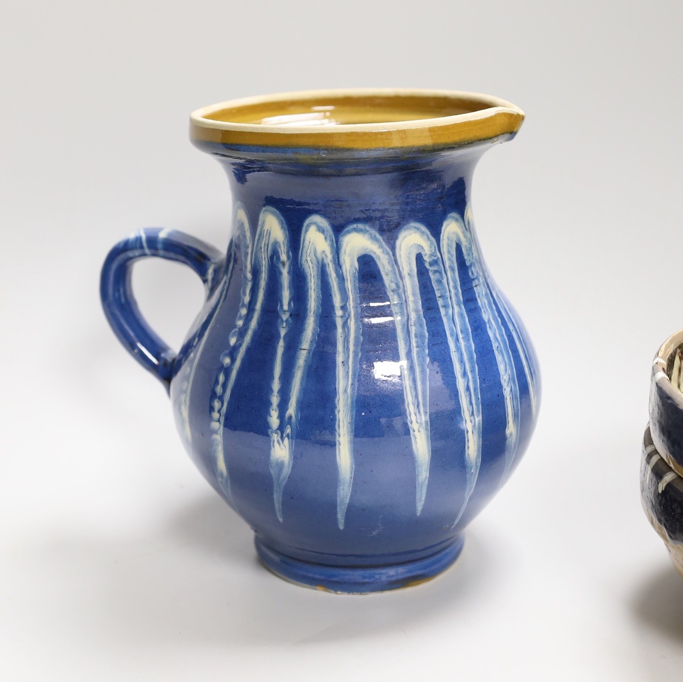 A group of six polychrome slipware bowls and a jug- 18cms high